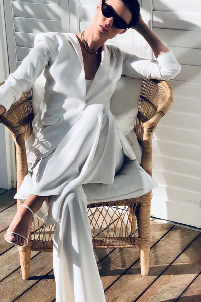 woman in white pantsuit pic
